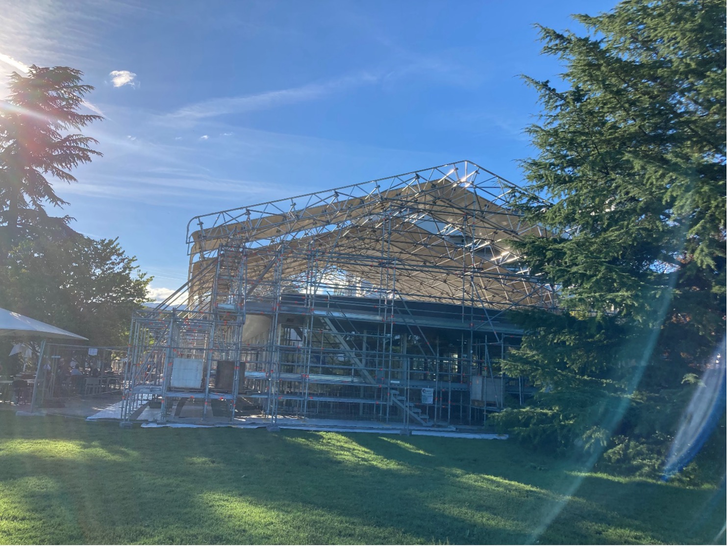 A building covered in scaffolding and protective covering