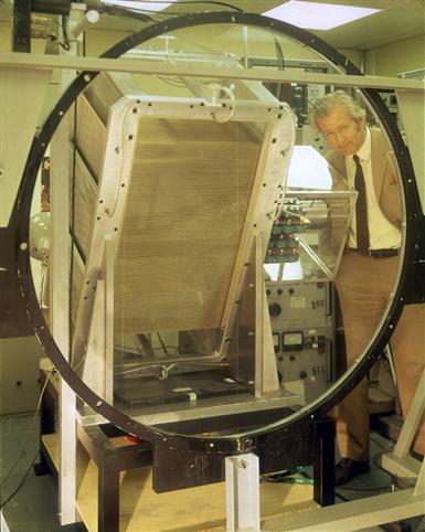 Man standing next to a detector